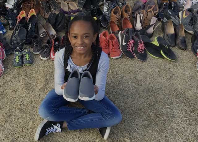 A drawing by a pre-k student of two hearts and a hand