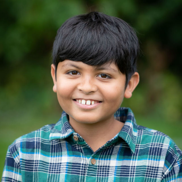 A drawing by a pre-k student of two hearts and a hand